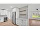 Modern kitchen featuring a white cabinets, herringbone backsplash, and stainless appliances at 6543 Tula Ln, Lakeland, FL 33809
