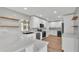 Modern kitchen featuring a white cabinets, herringbone backsplash, and stainless appliances at 6543 Tula Ln, Lakeland, FL 33809