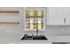 Kitchen sink with window, herringbone backsplash, and open shelving at 6543 Tula Ln, Lakeland, FL 33809