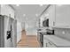 Modern, bright kitchen features stainless steel appliances, white cabinets, tile backsplash, and sleek countertops at 6543 Tula Ln, Lakeland, FL 33809