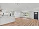 Open-concept living area with wood floors, white walls, and modern lighting at 6543 Tula Ln, Lakeland, FL 33809