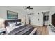 Serene main bedroom with gray accents, wood floors, and sliding barn doors at 6543 Tula Ln, Lakeland, FL 33809