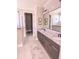 Elegant bathroom with double vanity, granite countertops, and modern fixtures at 7919 Lake James Blvd, Lakeland, FL 33810