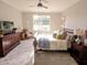 Bright and airy bedroom with carpet flooring, large windows, and comfortable furnishings at 7919 Lake James Blvd, Lakeland, FL 33810