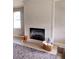 Bright living room featuring shiplap fireplace, plush gray rug, and modern decor at 7919 Lake James Blvd, Lakeland, FL 33810