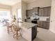 Well-equipped kitchen with granite counters, stainless appliances, island with seating, and views to dining area at 7919 Lake James Blvd, Lakeland, FL 33810