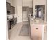 Spacious kitchen featuring stainless steel appliances, granite countertops, and an island with barstool seating at 7919 Lake James Blvd, Lakeland, FL 33810