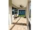 Screened lanai featuring brick pavers, ceiling fan, and bench with cushions at 7919 Lake James Blvd, Lakeland, FL 33810