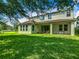 Spacious backyard featuring a well-maintained lawn and covered patio at 13525 Gorgona Isle Dr, Windermere, FL 34786