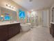 Bathroom featuring a soaking tub, glass shower, dual sinks, and a stained glass window at 13525 Gorgona Isle Dr, Windermere, FL 34786