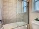 Bathtub shower with a glass door and tiled wall at 13525 Gorgona Isle Dr, Windermere, FL 34786