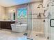 Well-lit bathroom featuring a soaking tub, glass shower, and stained glass window at 13525 Gorgona Isle Dr, Windermere, FL 34786