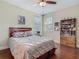 Bedroom features a wood-framed bed, hardwood floors, and bookcase at 13525 Gorgona Isle Dr, Windermere, FL 34786