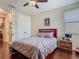 Bedroom features a wood-framed bed, hardwood floors, and double closet at 13525 Gorgona Isle Dr, Windermere, FL 34786