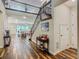Inviting foyer with wood floors, elegant staircase, and views into the living room at 13525 Gorgona Isle Dr, Windermere, FL 34786