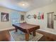 Spacious game room featuring a pool table, dark wood floors, and decorative wall art at 13525 Gorgona Isle Dr, Windermere, FL 34786
