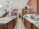 Well-lit kitchen featuring an expansive layout with a large center island, stainless steel appliances, and dark wood cabinetry at 13525 Gorgona Isle Dr, Windermere, FL 34786