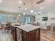 Open concept kitchen with large island, stainless steel appliances, pendant lights, and seamless flow to living spaces at 13525 Gorgona Isle Dr, Windermere, FL 34786