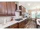 Modern kitchen featuring quartz countertops, stainless steel appliances, ample cabinetry, and an adjacent dining area at 13525 Gorgona Isle Dr, Windermere, FL 34786