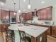 Well-equipped kitchen boasting an island with seating, stainless steel appliances, and modern pendant lighting at 13525 Gorgona Isle Dr, Windermere, FL 34786