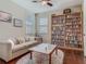 Cozy living room with large bookcase, comfortable couch, and beautiful area rug at 13525 Gorgona Isle Dr, Windermere, FL 34786