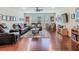 Spacious living room with hardwood floors, entertainment center, and comfortable leather seating at 13525 Gorgona Isle Dr, Windermere, FL 34786