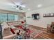 Bright living room featuring a comfortable sectional sofa, dark wood floors, and a glass coffee table at 13525 Gorgona Isle Dr, Windermere, FL 34786