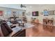 Bright living room with hardwood floors, an entertainment center, and cozy seating arrangement at 13525 Gorgona Isle Dr, Windermere, FL 34786