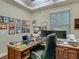 Comfortable office featuring a ceiling fan, wood floors, and a large window for natural light at 13525 Gorgona Isle Dr, Windermere, FL 34786