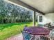 Relaxing outdoor patio area with ample seating, brick flooring, and a view of the lush backyard at 13525 Gorgona Isle Dr, Windermere, FL 34786