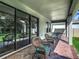 Cozy covered patio with brick flooring, comfortable seating, and sliding glass doors to the interior at 13525 Gorgona Isle Dr, Windermere, FL 34786