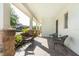 Charming front porch with stone columns, brick flooring, and comfortable seating arrangements at 13525 Gorgona Isle Dr, Windermere, FL 34786