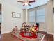 Bright sitting area with ceiling fan, vintage furniture, and unique decor at 13525 Gorgona Isle Dr, Windermere, FL 34786