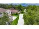Aerial view of a home with a long driveway, mature landscaping, and a well-maintained lawn at 1003 Clearpointe Way, Lakeland, FL 33813
