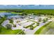 Overhead view of the community center, pool, and parking area surrounded by lush landscaping and trees at 1003 Clearpointe Way, Lakeland, FL 33813