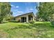 Expansive backyard showcasing the home's screened-in porch and landscaping at 1003 Clearpointe Way, Lakeland, FL 33813