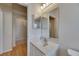 Bright bathroom with a vanity, mirror, and an archway leading to a shower at 1003 Clearpointe Way, Lakeland, FL 33813