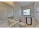 Accessible bathroom featuring a walk-in tub, a toilet, and a vanity with a mirror at 1003 Clearpointe Way, Lakeland, FL 33813