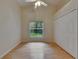 Bright bedroom features hardwood floors, a vaulted ceiling, a ceiling fan, and a closet with window views at 1003 Clearpointe Way, Lakeland, FL 33813