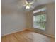 Bright bedroom features hardwood floors, vaulted ceiling, and large window with natural light at 1003 Clearpointe Way, Lakeland, FL 33813