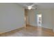 Bright bedroom boasts hardwood floors, a ceiling fan, and open access to a bathroom, enhancing convenience and comfort at 1003 Clearpointe Way, Lakeland, FL 33813