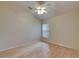 Empty bedroom with wood floors, a ceiling fan, and a window overlooking the yard at 1003 Clearpointe Way, Lakeland, FL 33813