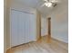 Bedroom with hardwood floors, a ceiling fan, closet with folding doors, and white trim at 1003 Clearpointe Way, Lakeland, FL 33813