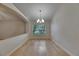 Dining room features hardwood floors, a hanging chandelier, and a large window at 1003 Clearpointe Way, Lakeland, FL 33813