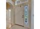 Light-filled foyer with tile flooring, a side window, and an arched doorway at 1003 Clearpointe Way, Lakeland, FL 33813