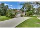 Charming single-Gathering home boasts mature landscaping, a two-car garage, and a well-maintained lawn at 1003 Clearpointe Way, Lakeland, FL 33813
