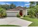 Charming single-story home with a well-manicured lawn and a bright red front door at 1003 Clearpointe Way, Lakeland, FL 33813