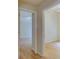Hallway featuring hardwood floors, leading to bright, airy rooms with ceiling fans and ample natural light at 1003 Clearpointe Way, Lakeland, FL 33813