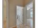 Hallway with multiple doorways leading to a laundry room and a bedroom with a ceiling fan at 1003 Clearpointe Way, Lakeland, FL 33813