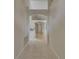 Hallway features ceramic tiles and arched opening with hardwood floors beyond at 1003 Clearpointe Way, Lakeland, FL 33813